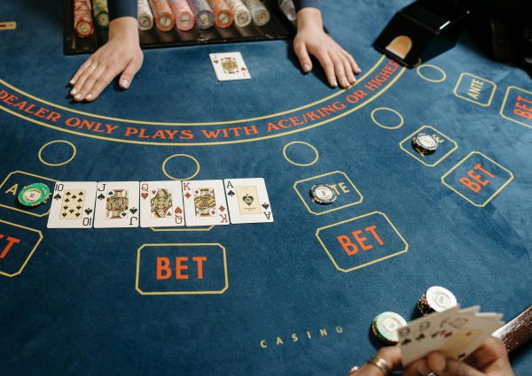 A casino gaming table featuring poker cards and chips, showcasing a vibrant gambling scene.